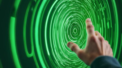 Wall Mural - hand reaching towards green digital screen creating puzzle-like effect in modern atelier setting wit
