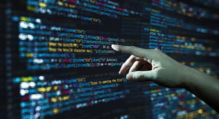 Wall Mural - human hand pointing at the abstract modern tech of programming code screen developer. c programming 