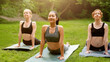 © Prostock-studio - Peaceful Asian woman and her friends practicing outdoor group yoga at park