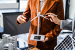 © Phushutter - Two businesswomen sit at a desk in a meeting, discussing property development while building a model of city tower. real estate investments, zoning laws, sustainable energy solutions. net zero
