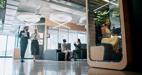 Poster - Collaboration, conversation and walking with business people in lobby of office for planning. Discussion, documents and teamwork with employee on video call in pod for development, feedback or review