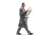 © Ljupco Smokovski - Man in a bathrobe walking and reading a newspaper