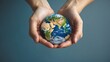 © fotofabrika - Hands holding a small Earth model symbolizing care for the planet and environmental awareness in a serene setting