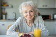© Dennis - Senior having a healthy breakfast with cereals, berries, and apple juice in the kitchen