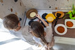 © Iryna - Children making pancakes together in the kitchen. Two children, a boy and a girl, prepare pancakes on a stovetop in a home kitchen, working together to cook a delicious meal.