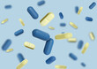 © New Africa - Many different pills flying on light blue background