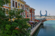 © Travel 'n' Lifestyle - View of colorful buildings and a canal with a bridge in a vibrant skyline, Al Souq, Doha, Qatar.