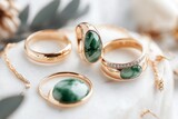 A collection of jade jewelry, including rings, necklaces, and earrings, elegantly arranged on a white marble surface