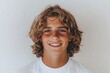 © Amat - Smiling teen boy indoor on white background