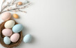 © Sung Hwan Kim - colorful easter eggs, nests, and willow branches on a white background with empty space in the center for text or design