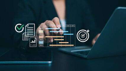 Project management tool and work schedule concept, Planning software, Businessman use laptop to manager working projects and update task with gantt chart schedule to business plan and progress.