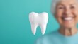 © Slowlifetrader - The right to dental care for the elderly. Government support for dental treatment. Oral and gum health care. A dental model with an elderly person in the background.