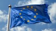 © Dmitrii - European Union EU flag on a pole waving in the wind with a blue sky on a sunny day as background