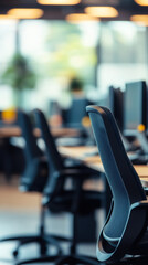 Poster - Ergonomic chairs and desks filling an empty office, ready and waiting for employees to begin their workday in a modern workspace