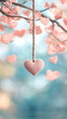 © Michael - Pink heart hanging from a rope with blurred heart-shaped leaves in the background and a turquoise bokeh