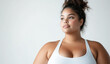 © Soloviova Liudmyla - Realistic studio photo of big fat female model with big breasts wearing bodysuit with thin straps standing next white wall while soft lighting enhances minimalistic professional fashion aesthetic