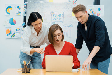 professional business team working together by using laptop in start up project at meeting in front 