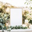 © Vitalii - Blank gold mock up frame on an outdoor table decorated with green branches