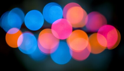 Wall Mural - blurry colorful glowing circles arranged against a dark background