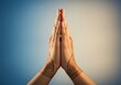 © IbragimovN - Henna adorned hands in namaste pose against gradient background