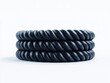 © Nucharee - Black braided rope stack, studio shot.