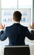 © Mr image - Focused Business Presentation: An executive, seen from behind, passionately conveys complex data during a presentation, using expressive gestures and charts to engage his audience.