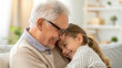 © Nastassia - An elderly man in glasses communicates with his granddaughter. Their smiles and kind looks convey the warmth of family ties.