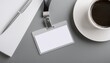 © photostockatinat - an ID badge, notepad, pen, and coffee cup arranged on a desk, ready for work