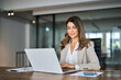 © insta_photos - Busy mature business woman working in office using laptop. Mid aged female professional businesswoman executive manager wearing suit looking at computer thinking on digital strategy, sitting at desk.