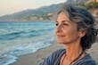© Vlad - Menopausal Woman Looking Happy at the Autumn Beach in Italy