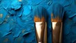 © PANGERANDESIGN - Blue paint brushes on textured blue paint background