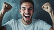 © Sona - Excited man expressing emotions. Close-up of a happy man with a joyful facial expression, raising arms in a winner gesture and smiling in celebration of success.