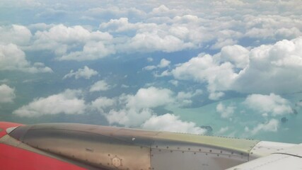 Wall Mural - blue sky with white fluffy clouds from airplane flight fly over the clouds in a sunny day with cloud moving in the atmosphere and view of plane engine in hot weather summer time