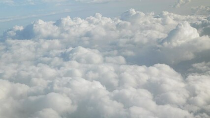 Wall Mural - blue sky with white fluffy clouds from airplane flight fly over the clouds in a sunny day with cloud moving in summer, summer cloudscape background