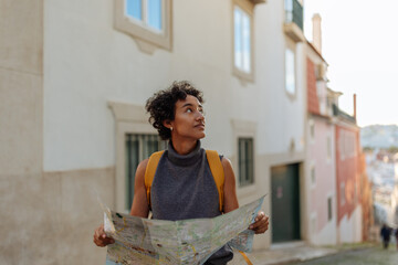 tourist exploring lisbon using a map and looking around