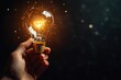 © sukrisna - Hand holding illuminated lightbulb