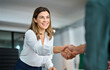 © insta_photos - Happy mature professional business woman handshaking partner in office. Smiling female hr manager of middle age making successful deal with partner shaking hand of client at work standing at meeting.