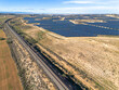 © yaqui_villegas - Wide aerial perspective of a large solar farm in a rural area, showcasing sustainable energy production in Zaragoza.