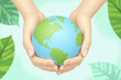 © He - two hands holding a globe with green leaves around it
