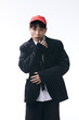 © LIGHTFIELD STUDIOS - Stylish young asian man poses confidently in a modern urban setting during bright daylight