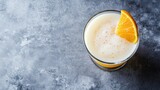 Homemade whiskey sour in coupe glass on gray background. Overhead view with copy space for cafe advertising.