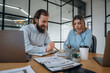 © standret - Friendly atmosphere, cup of coffee and laptops. Man and woman are in the office together