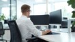 © Exnoi - Focused Man Working at Modern Office Desk with Dual Monitors
