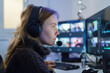 © Purple_Lamp - Young caucasian woman focusing on video editing at a computer workstation in a modern office environment