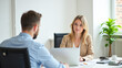 © Radorog. - a businesswoman with a laptop in the office interviewing a client