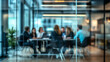 © Yuwarin - A business team working in a modern office meeting room. Blurred people