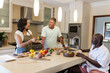 © Wavebreak Media - Diverse group of senior friends preparing healthy meal together in modern kitchen