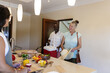 © Wavebreak Media - Senior friends enjoying cooking together in modern kitchen, preparing fresh ingredients