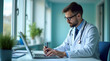 © HaJung - Modern Doctor Writing Medical Notes on Laptop in Hospital Setting