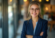 © PhotoProAD - A woman wearing a blue suit and glasses